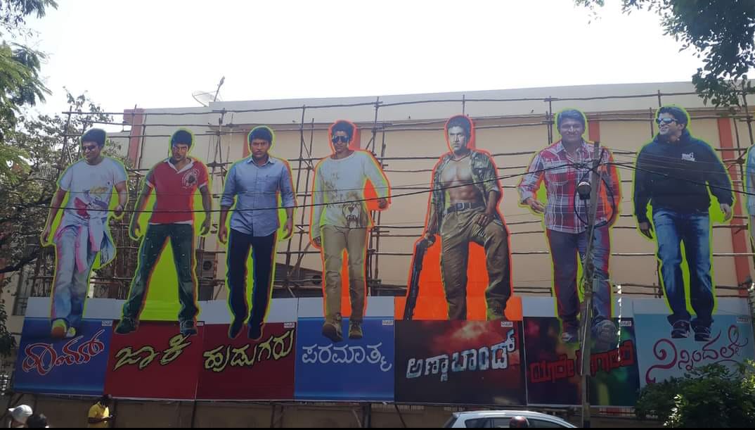 sharadasrinidhi's tweet photo. .. #ಜೇಮ್ಸ್_ಉತ್ಸವ
From #Appu to #James Mega cut outs of the #Powerstar at #Veeresh theatre ahead of #James release coinciding with the acto's #birth anniversary 
#AppuLiveson #RajabhimanigalaSangha  #CelebratePuneethRajkumar #VeereshTheatre #FansShows https://t.co/HODszfEKFe