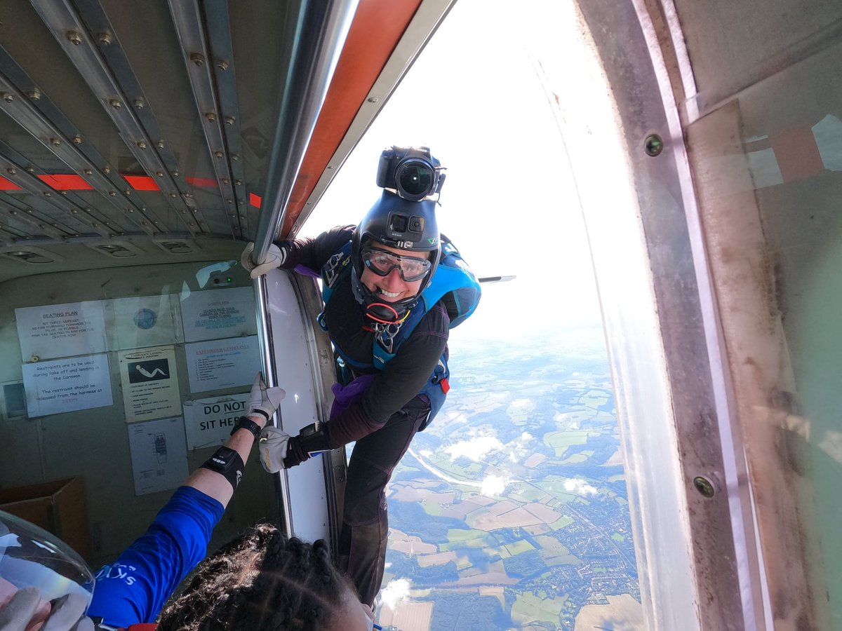 ukskydive's tweet photo. Smile - you're on camera! Instructor and camerawoman Sharron Floyd pictured by fellow camera flyer Tim Lawson - we can verify that Sharron is ALWAYS smiling even hanging off the outside of a plane travelling at 90mph! #sharronfloyd #freefallcamera #skydivinglondon #skydive2022 https://t.co/SS1J4hgcmj
