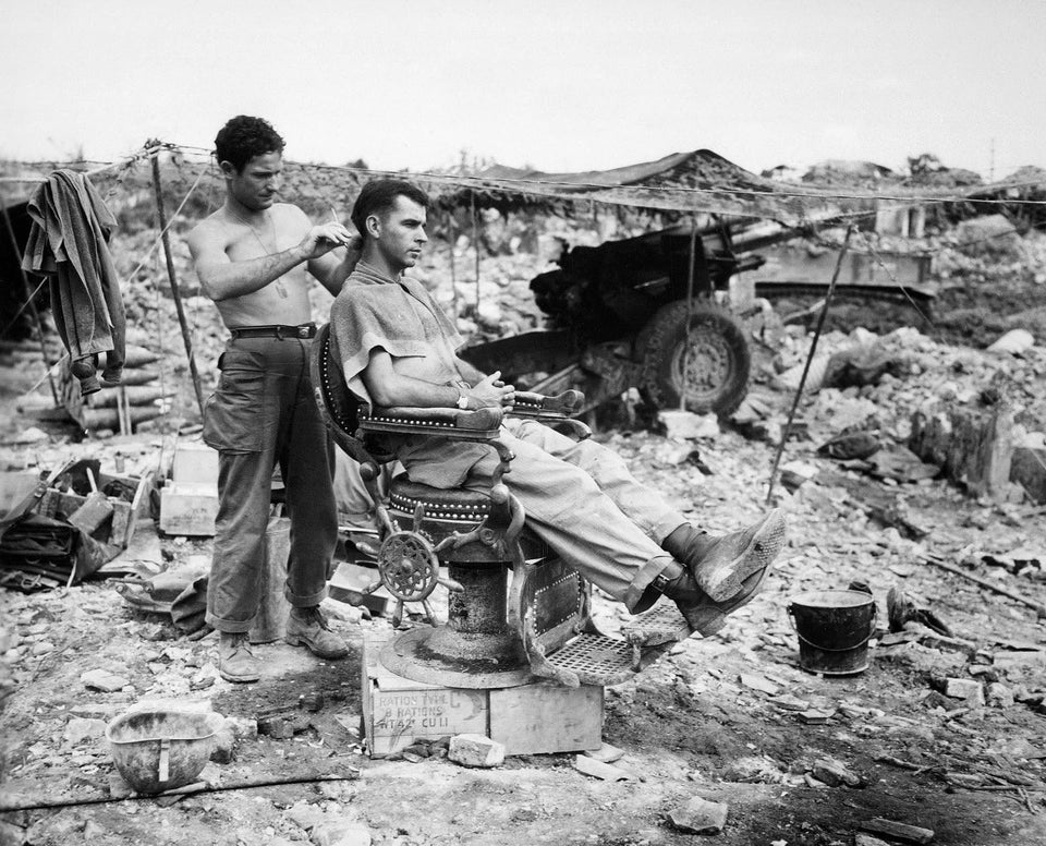 WW2Facts's tweet image. Two men from the 363rd Field Artillery Battalion take advantage of an abandoned barber shop chair on Okinawa on June 10, 1945.

#History #WWII