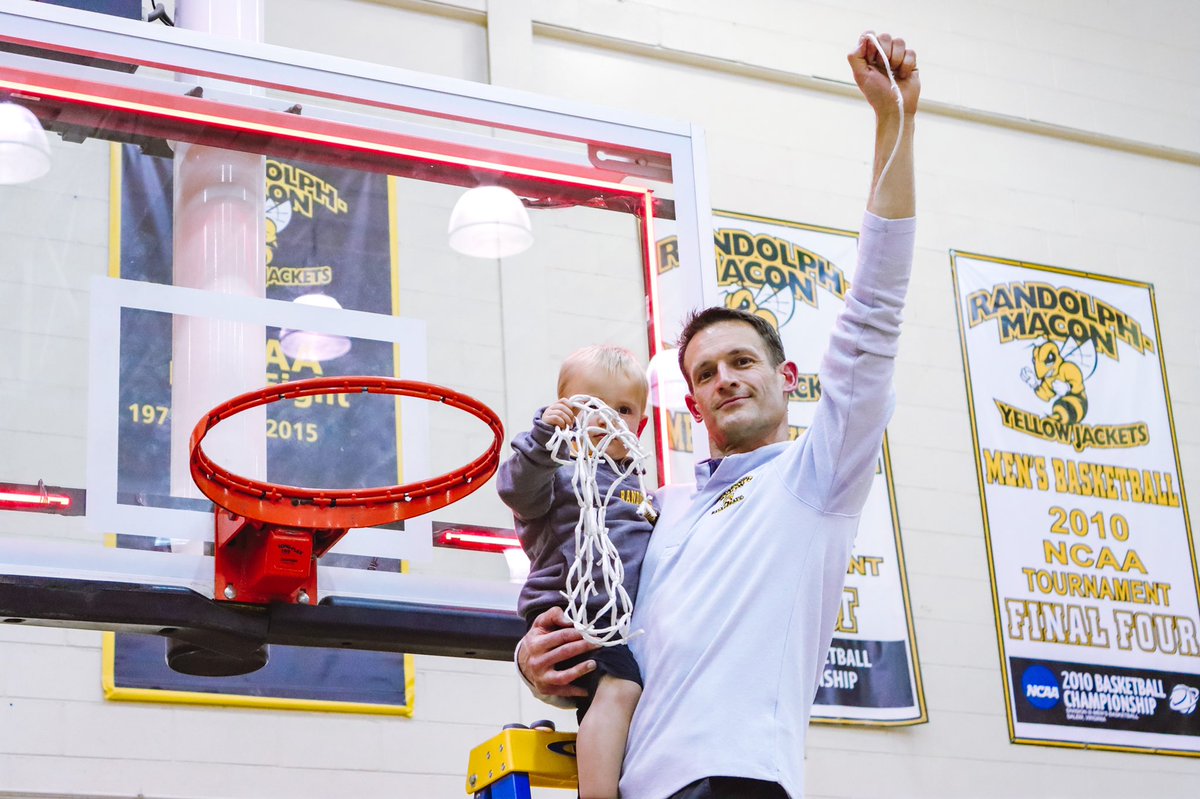 Coach Merkel holds his child and the net he just cut off the backboard
