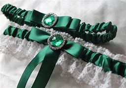 Sage went back over to the table took off her garter belt, And grabbed the flowers. She wrapped the garter belt around the stems of the flowers and stood up off the chair. Making her way to the centre of the room. "Going to throw these flowers now"