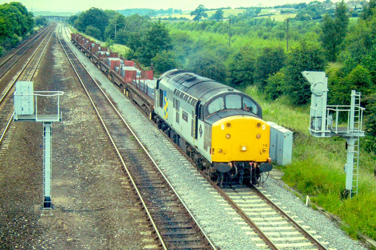 Heavyweight 37716 ‘British Steel Corby’ pauses at the signal near  Clay Cross with a fully loaded steel train. #Class37 #BritishRail #ClayCross #Trainspotting