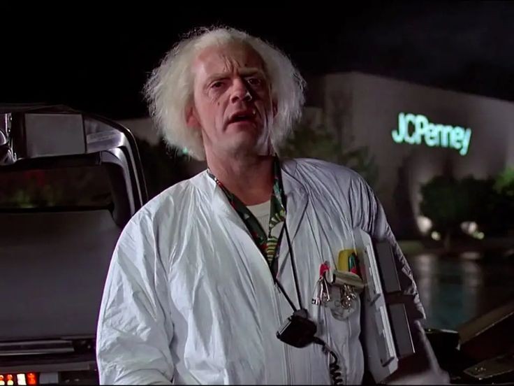 Как зовут дока из назад в будущее. Профессор эммет браун. Назад в будущее back to the future 1985. Профессор эммет браун и машина времени. Назад в будущее 3 фильм 1989.