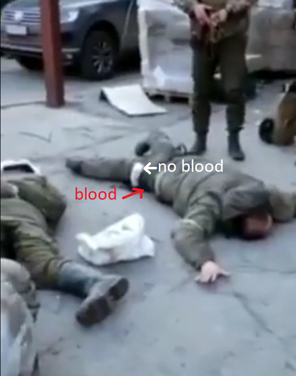 In the 1st and longer vid, the legbands are very very clean despite the blood being under it. It seems the russian soldiers just laid on the blood. 2/3