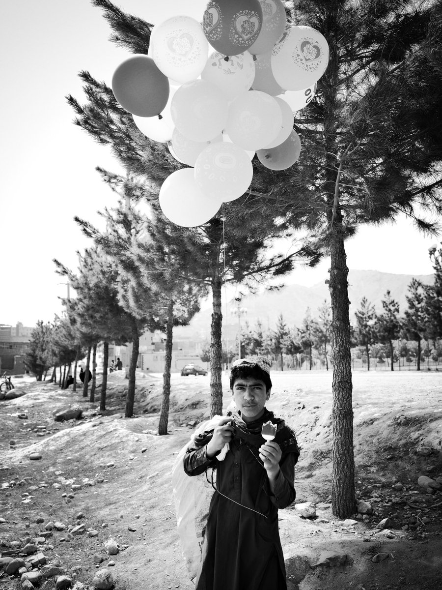 This young man sells balloons on the streets of Kabul to support his family.