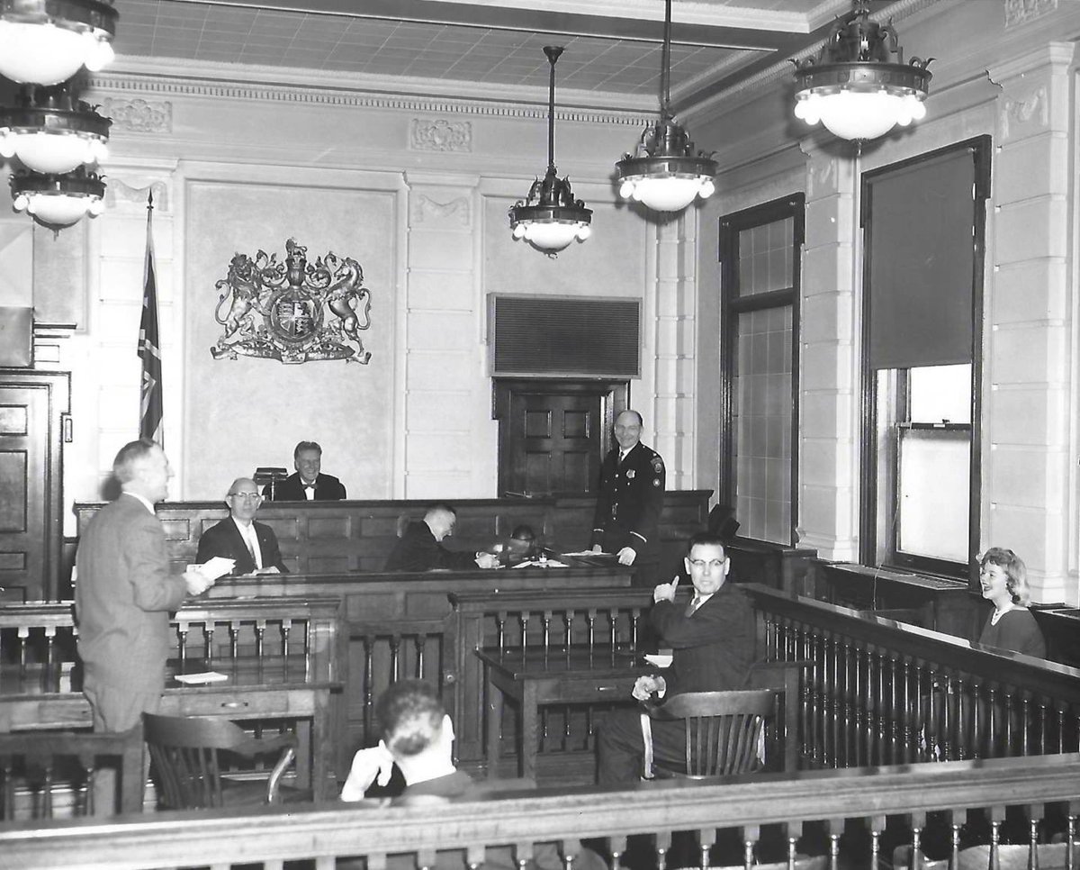 HPS_Museum's tweet photo. Inside Wentworth County Courthouse. Chief Lawrence seated in the Judges position, Deputy Chief Arno standing. #HPSArchives #PoliceHistory #HamOnt #HamOntHistory #HPSHistory https://t.co/p4Zq7gUtZ2