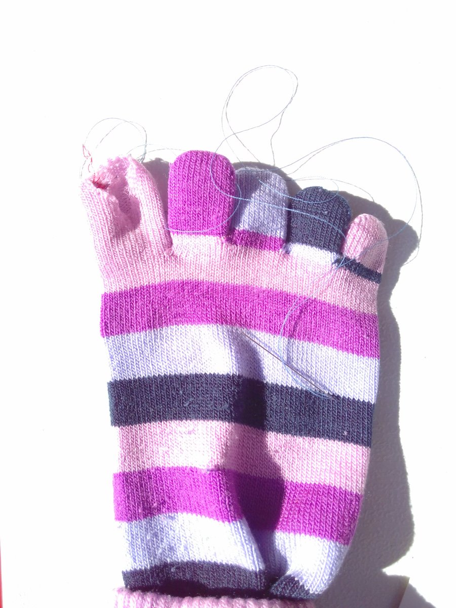 patch_pop's tweet image. Excellent toe-darning in progress. This is an awkward mend, as we haven't had access to a small darning mushroom - a glue stick is doing the job(ish)!