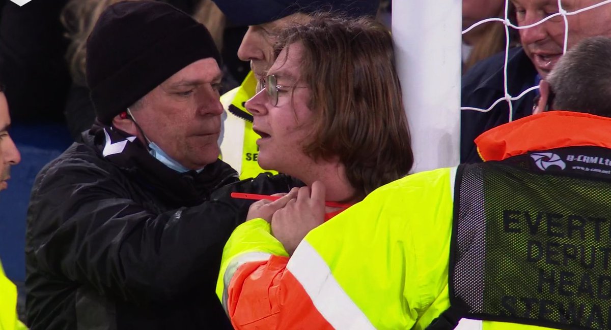 sportbible's tweet image. A protestor has attached themselves to the goalpost by their neck 🤯