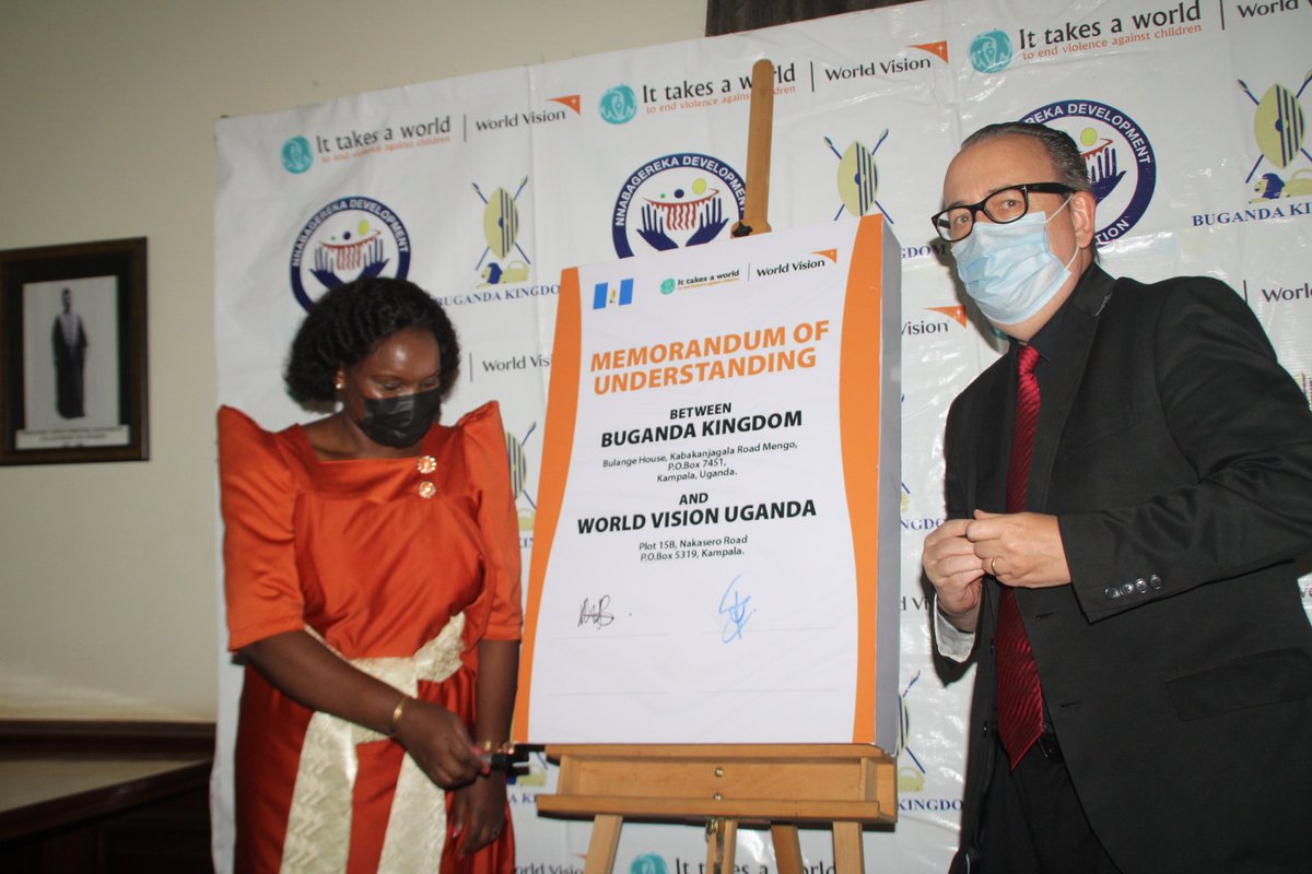 Oweek Dr Prosperous Nankindu Kavuma on behalf of Buganda Kingdom and Nnabagereka Development Foundation signs the MOU alongside <a href="/WorldVisionUg/">World Vision Uganda</a> Country Director.
