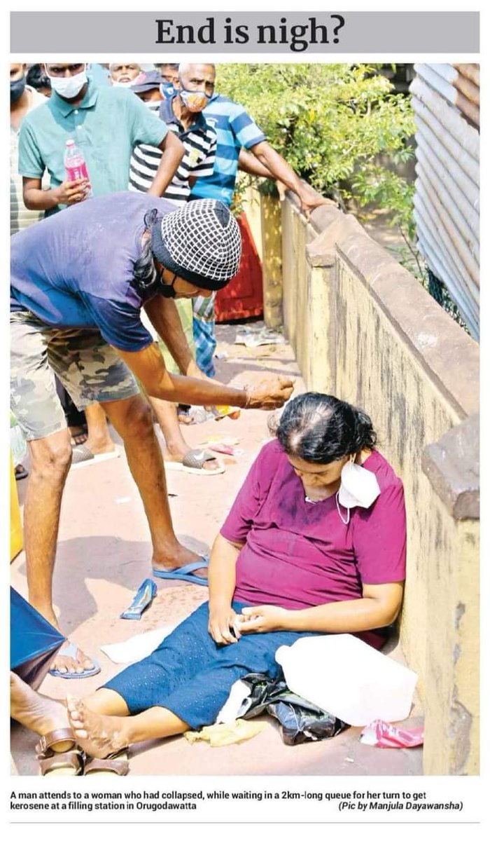 alexandersagdev's tweet photo. A man attends to a woman who had collapsed, while waiting in a 2km-long queue for Kerosene in Sri Lanka.

#prayforsrilanka https://t.co/PGY5vo9IyK