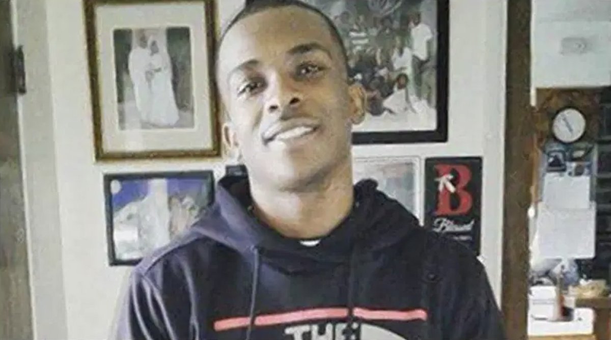 A photo of Stephon Clark, from the shoulders up, smiling and looking at the camera.