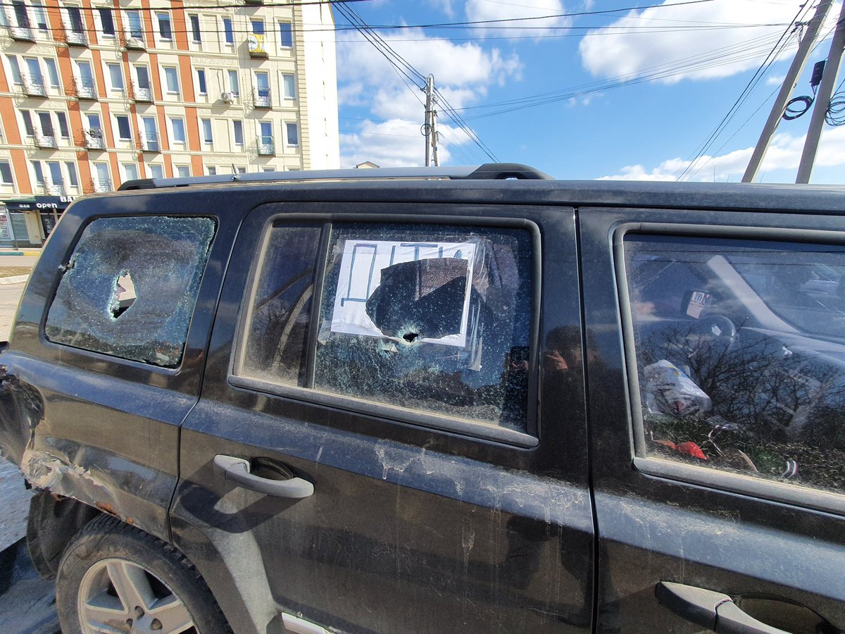 This is a car in Stoyanka, outside Kyiv. Note that the paper sign saying 'children' had been shot through.