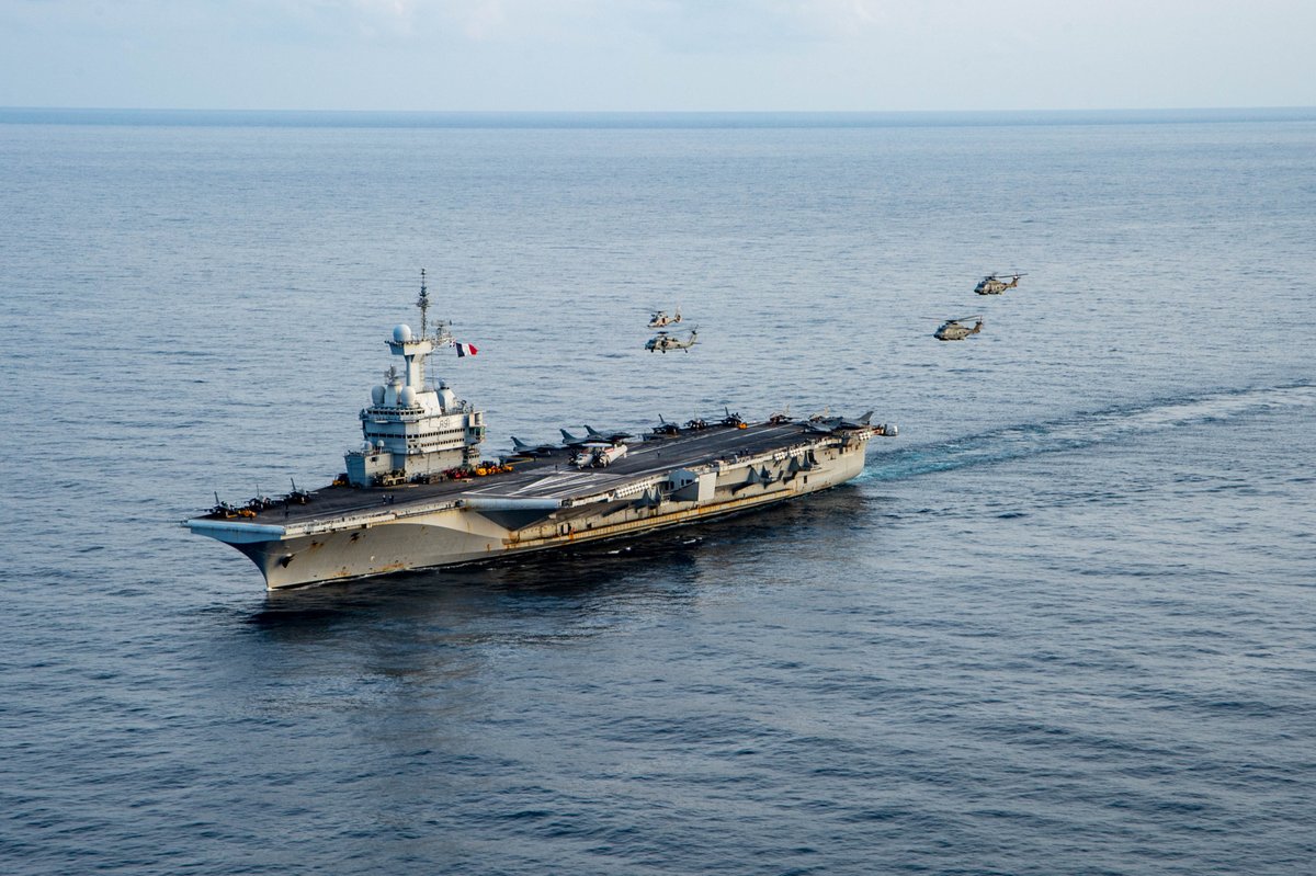 An MH-60S Sea Hawk helicopter, attached to the "Dragonslayers" of Helicopter Sea Combat Squadron (HSC) 11, a Eurocopter AS365 Dauphin helicopter, attached to the French aircraft carrier Charles de Gaulle (R 91) and two NHIndustries NH90 helicopters, attached to the Italian aircraft carrier ITS Cavour (C 550), fly in formation alongside the Charles de Gaulle, Mar. 17, 2022. The Harry S. Truman Carrier Strike Group is on a scheduled deployment in the U.S. Sixth Fleet area of operations in support of U.S., allied and partner interests in Europe and Africa. (U.S. Navy photo by Mass Communication Specialist 3rd Class Bela Chambers)