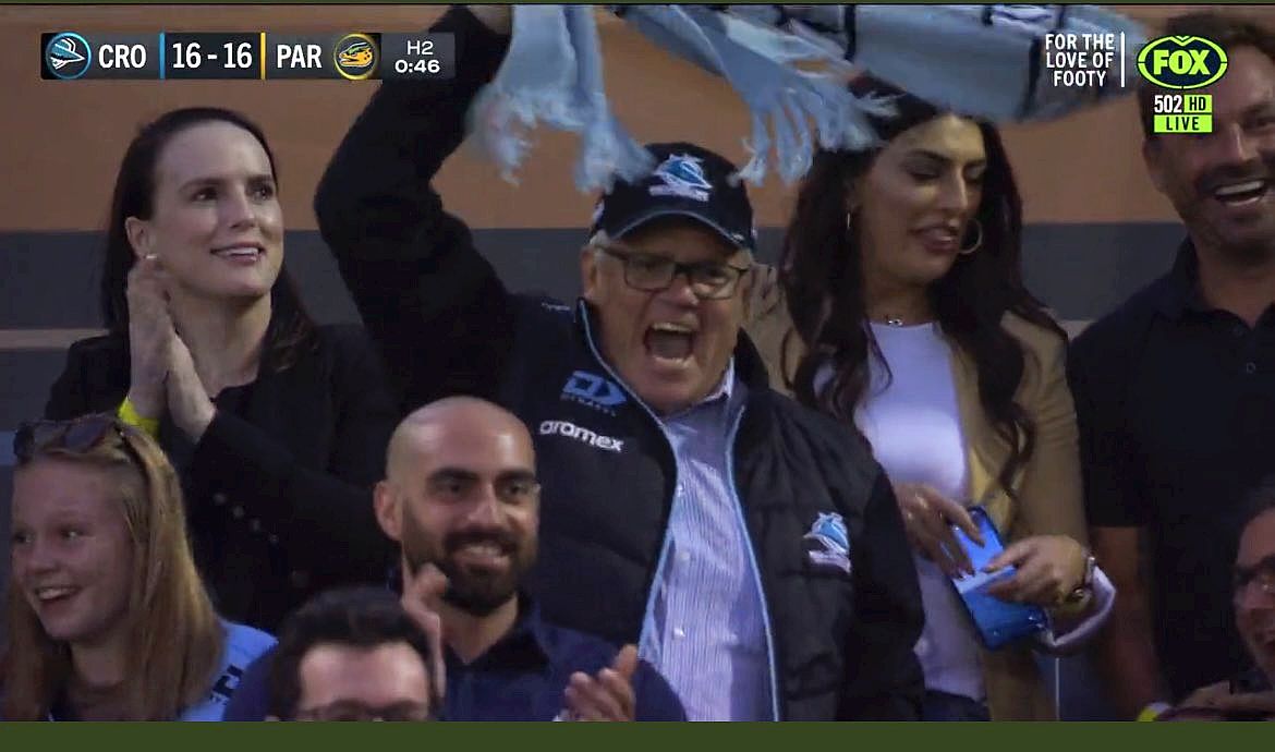 Seldomsean63's tweet photo. Guess what #Scomo was doing when #LNP was losing the #SAElection2022 , yeah that's right sitting at the footy with all his mates looking like a real 'wally'  #WhereIsScotty #Auspol 
#CallTheElectionDickhead 
I'm thinking the woman behind him is thinking #ScottyTheCompletePsycho ! https://t.co/JoRUITofHL