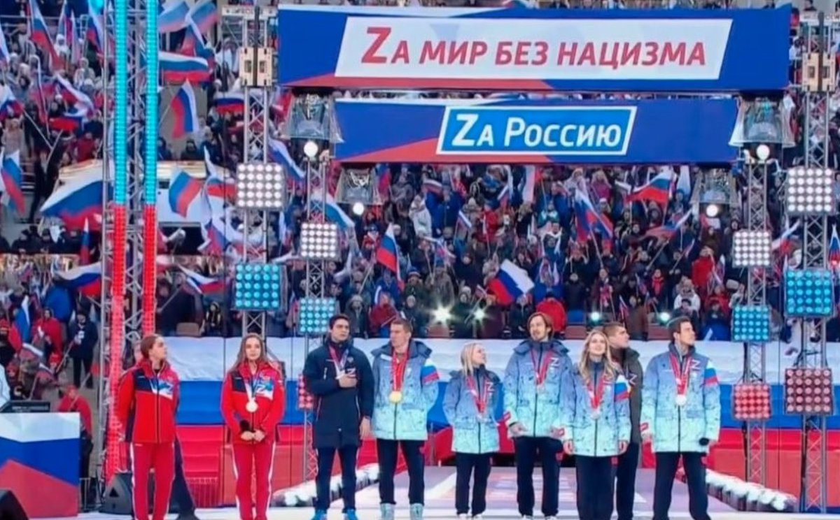 rwesthead's tweet photo. Russian Olympic figure skaters, gymnasts, skiers - wearing their medals and ‘Z’ symbols in support of Vladimir Putin's war in Ukraine - appear on stage at a rally in Moscow with Putin.
Never more clear that international sports has become a cultural and political battleground. https://t.co/7RwX3rKqUo
