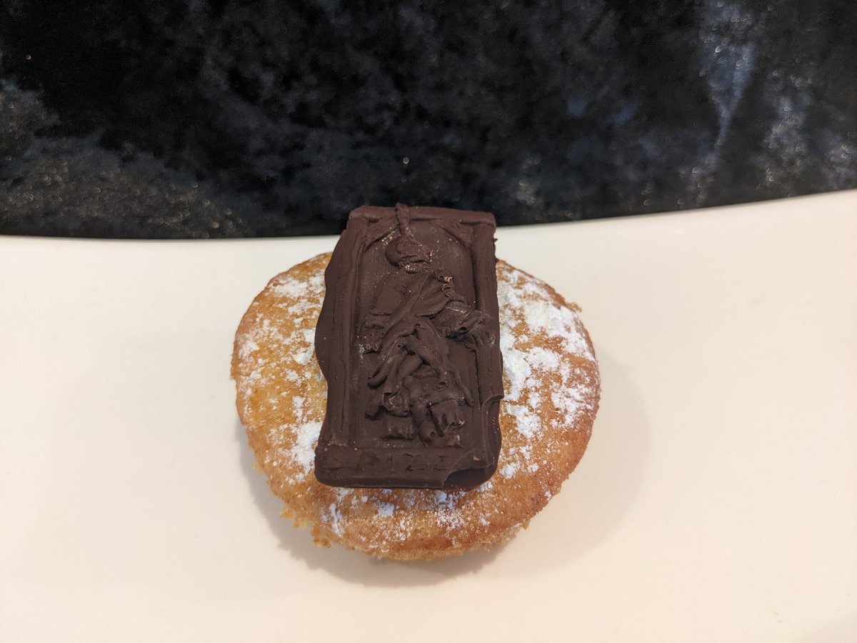 Orange cupcake with chocolate Pazzi decoration on top