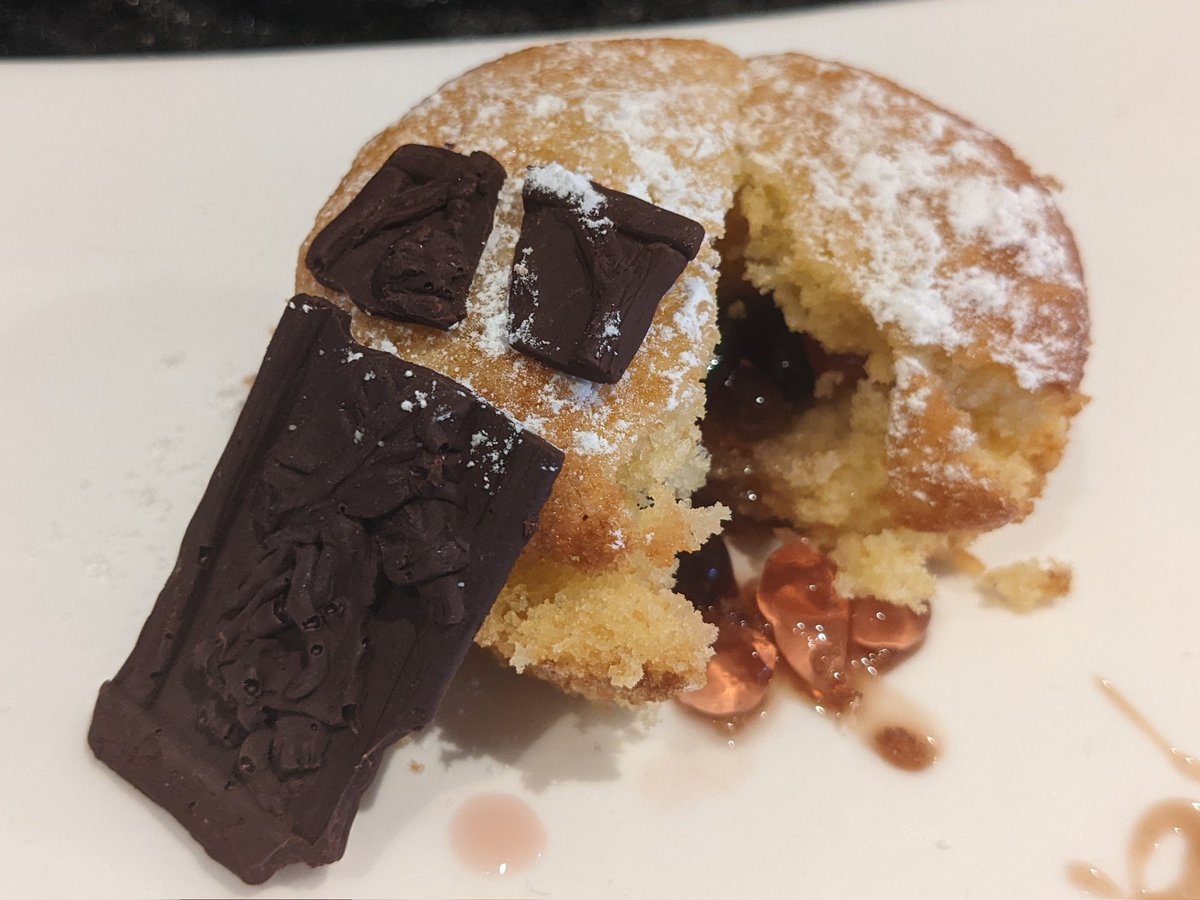 Orange cupcake with broken chocolate and bowels spilling out