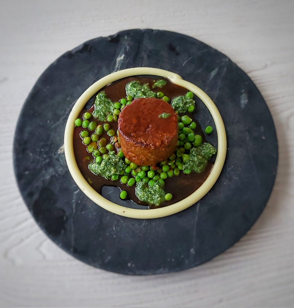 Slow cooked lamb shoulder, jus, peas and broadbeans, mint pesto, garlic puree.