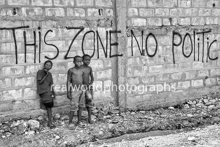 A few boys outside the walls of a Jacmel refugee camp in 2010. Gary Moore photo. Real World Photographs. #world #photography #Haiti #realworldphotographs #photojournalism #photography #children #poverty 