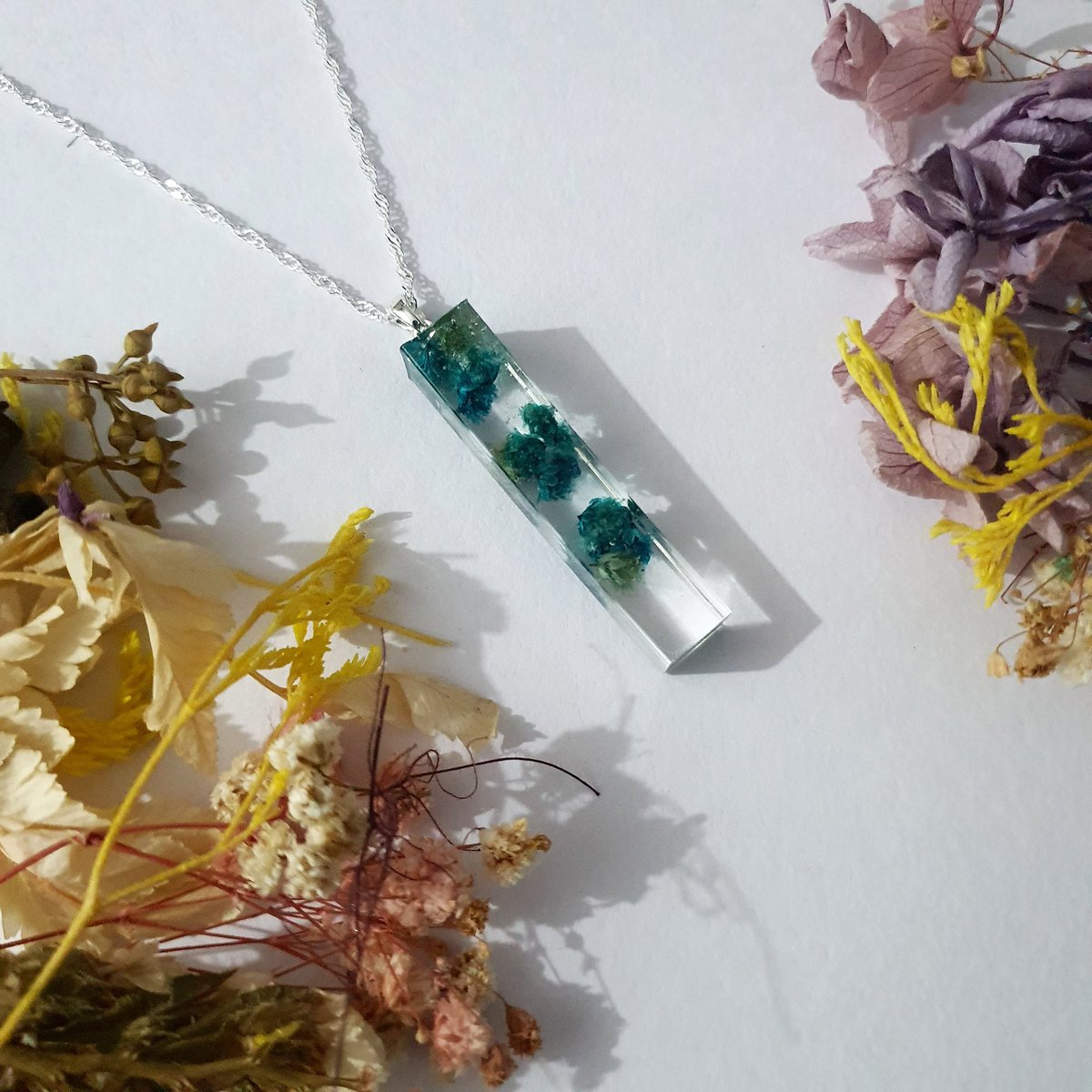 ishaqgems_'s tweet photo. Natural Blue Dried Flowers Necklace that comes with a 925 silver bail and chain.
Available on our website 🎁 
.
.
.
#ishaqgems #necklace #jewellery #jewelleryshop #handcrafted #handmadenecklace #preservedflower #resinnecklace #handmade #resinjewellery #resin #silvernecklace https://t.co/3g7kY70gIK