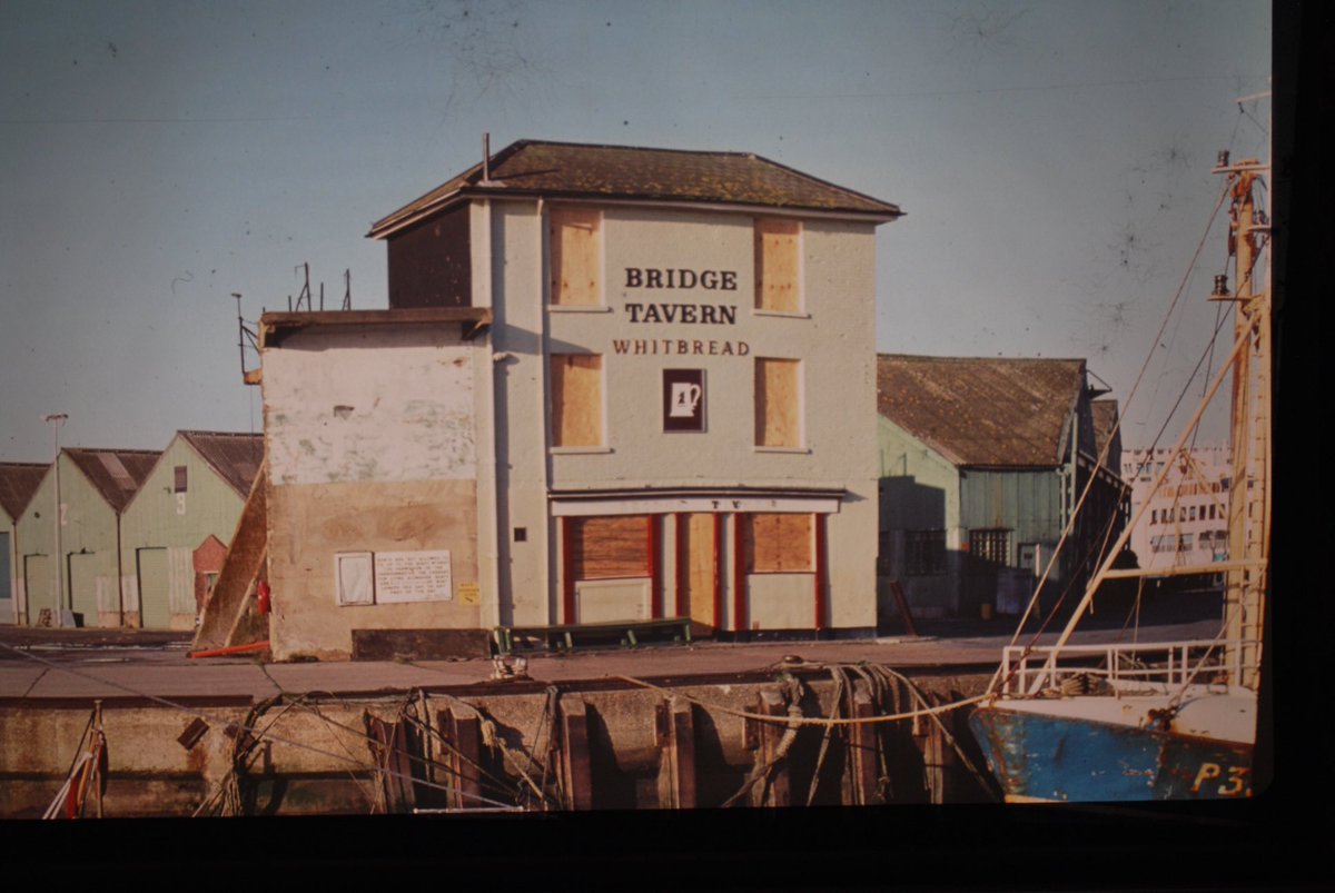 HCT66's tweet photo. A reminder that the Bridge Tavern nearly did not survive the closure of the Camber commercial docks at the end of the 1970’s.  To the left note the last section of the wall around the Fraser-Whites coal depot which stretched almost back to Broad St https://t.co/zNuZs2w31c