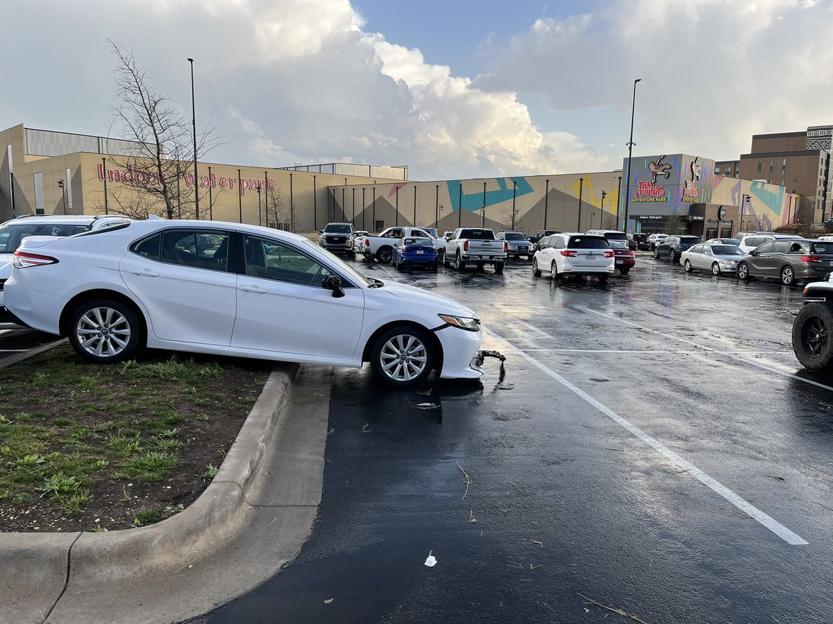 MikeMarut_'s tweet photo. More damage: windows blown out, a car popped up on the curb, roofing underneath cars in the parking lot here at Kalahari. @KVUE https://t.co/TrD3Mwkj3p