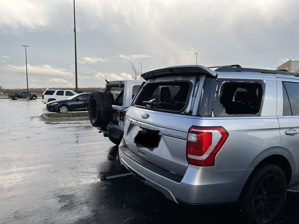 MikeMarut_'s tweet photo. More damage: windows blown out, a car popped up on the curb, roofing underneath cars in the parking lot here at Kalahari. @KVUE https://t.co/TrD3Mwkj3p
