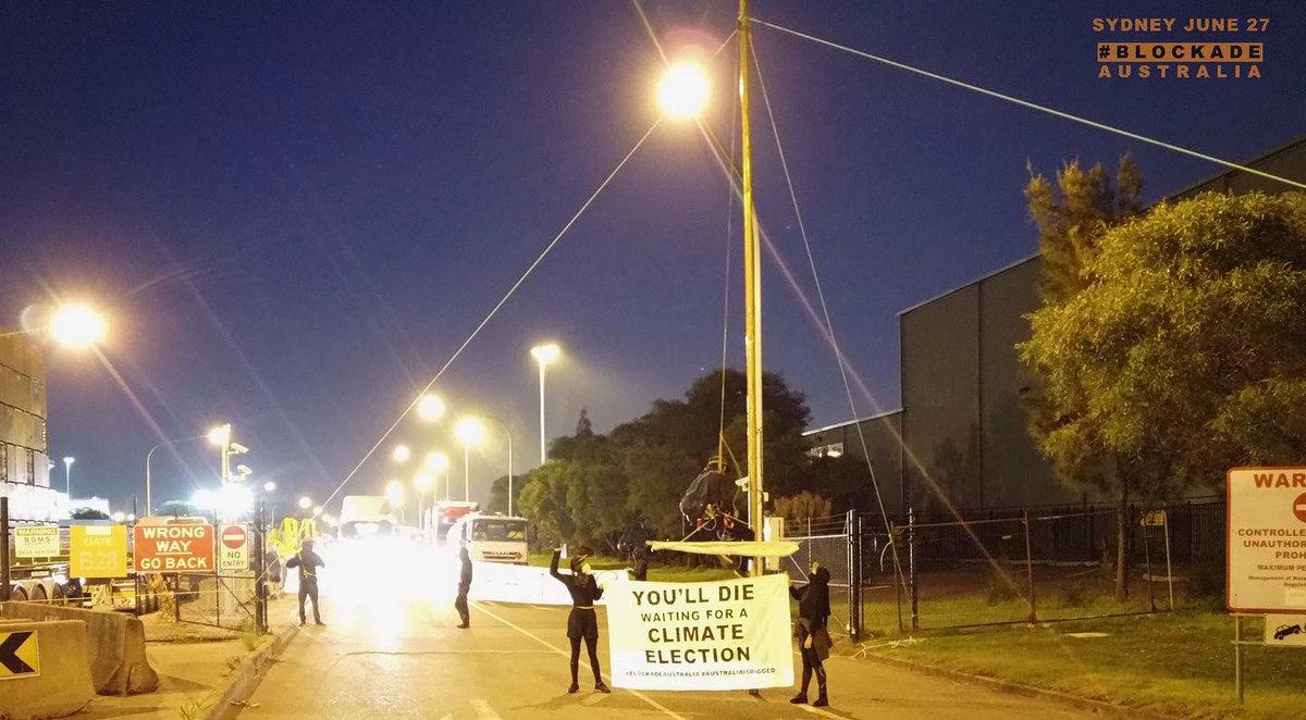 BlockadeAus's tweet photo. “We live under this illusion that we can go and elect a new government that cares about the climate crisis and the people.” Tom, suspended from a monopole, blockading Port Botany. #ClimateChaos https://t.co/R8JnK7xkco