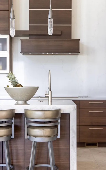 Take a look at this beautiful kitchen! Finished last year, it features walnut cabinets, a quartzite island countertop with a waterfall pane, and a Pental quartz perimeter countertop and backsplash slab.
<a href="/martineauhomes/">Martineau Homes</a>