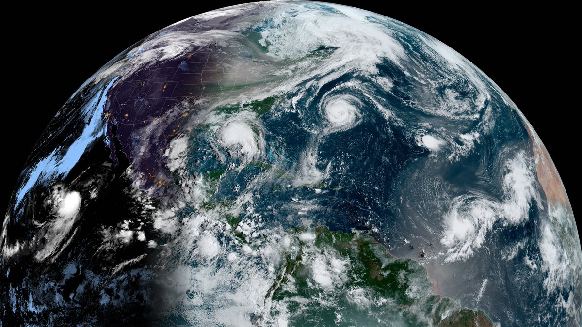 Satellite photo of the globe with several hurricanes visible