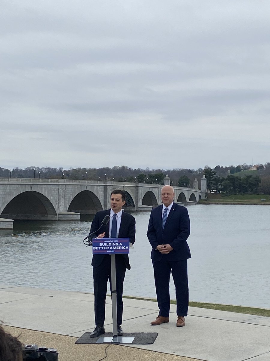 Secretary Pete and Mitch Landrieu in front of the Memorial Bridge