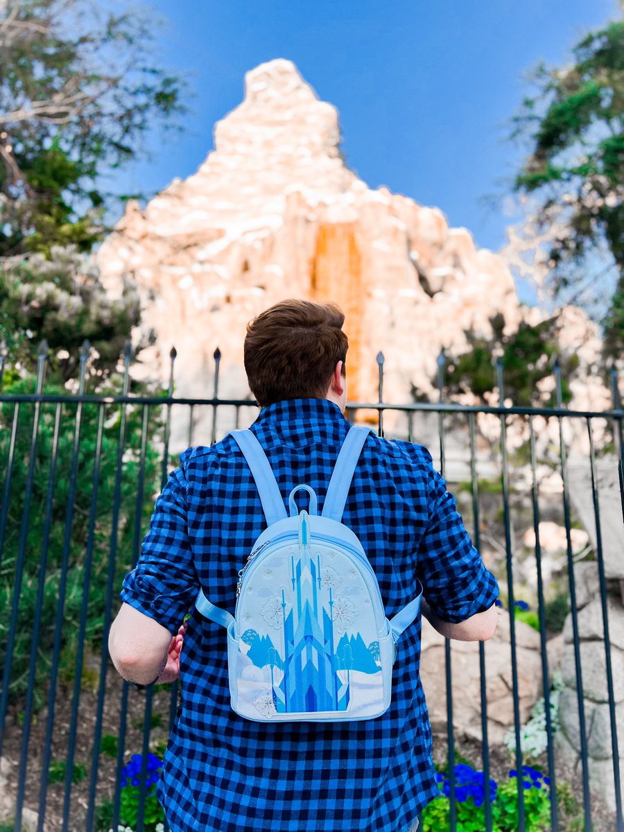 Loungefly's tweet photo. A palace made of ice? Yes please! ❄️🏰 We are excited to give a first look at the new #Loungefly Disney Frozen Elsa Ice Castle mini backpack ~ available Thursday, 3/24 at 6pm PST exclusively at @worldoneonegame! 
https://t.co/OeNoR9L4NJ https://t.co/Cyg8KzzSgI