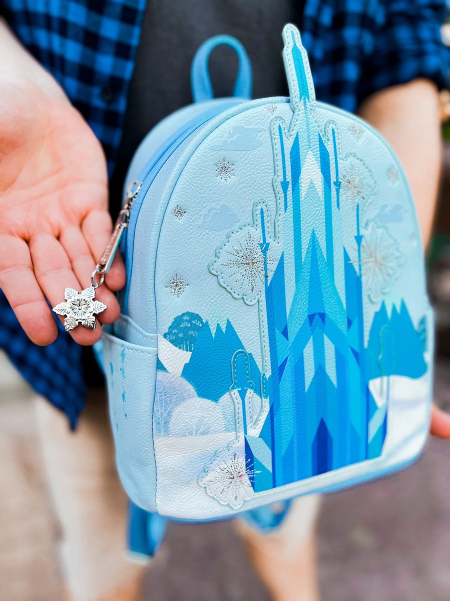 Loungefly's tweet photo. A palace made of ice? Yes please! ❄️🏰 We are excited to give a first look at the new #Loungefly Disney Frozen Elsa Ice Castle mini backpack ~ available Thursday, 3/24 at 6pm PST exclusively at @worldoneonegame! 
https://t.co/OeNoR9L4NJ https://t.co/Cyg8KzzSgI