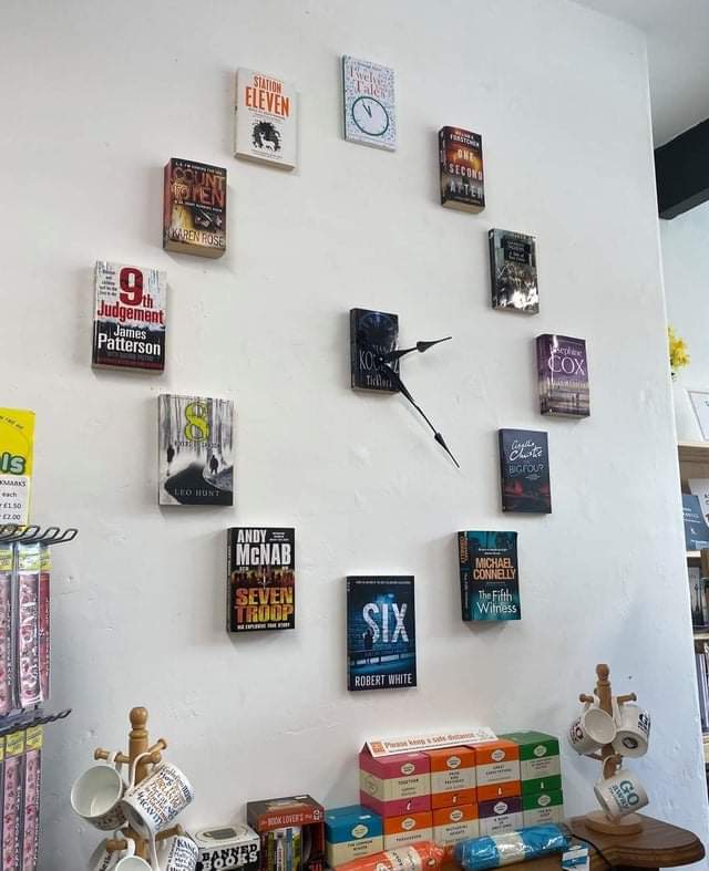 A wall clock made from books that have numbers on their covers. In a bookstore in Kirkby Lonsdale, England.