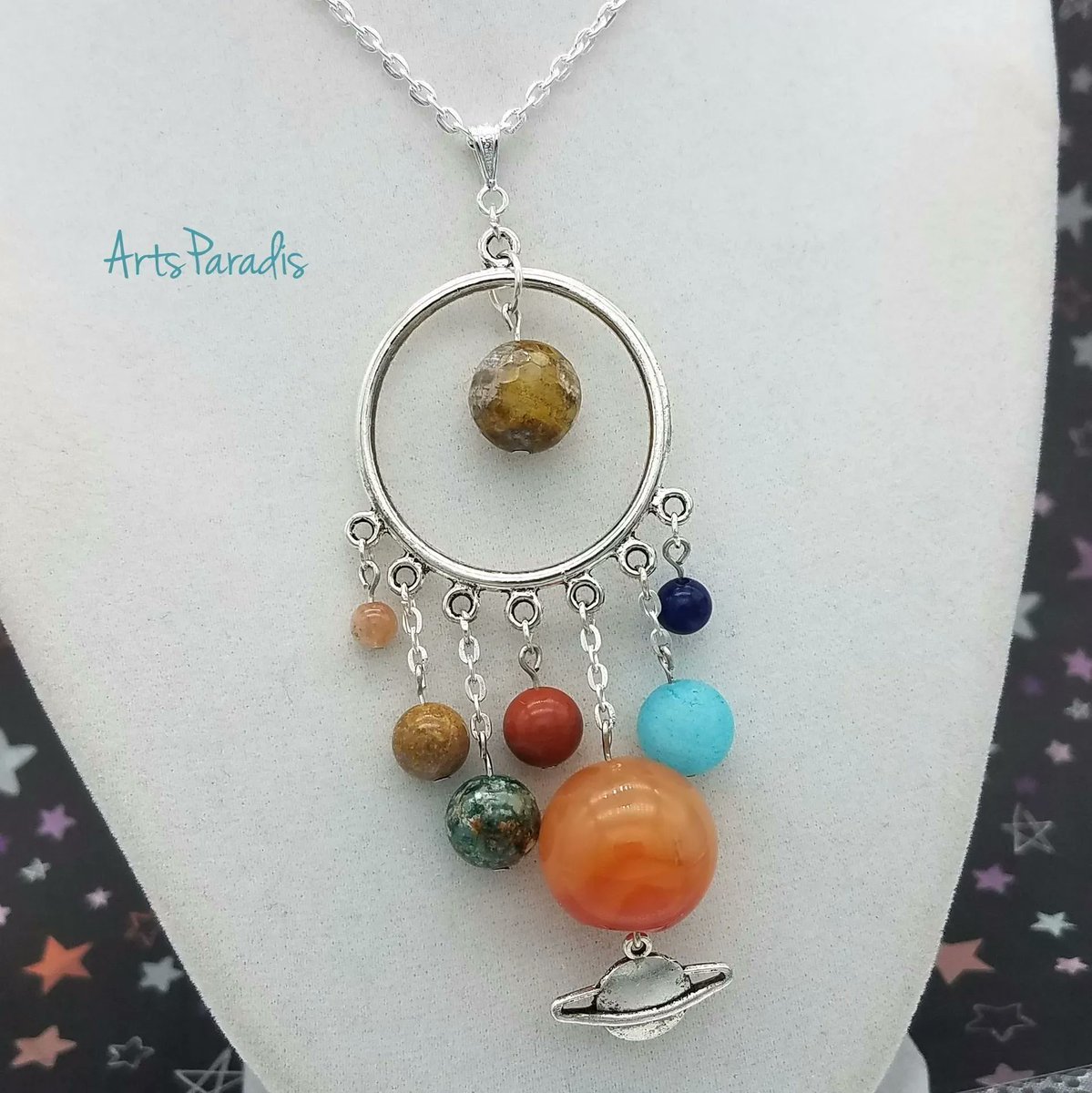 I was inspired by a picture of a bunch of globes. It's not to scale but I think the colors and relative sizes give the right impression. This feels like a Ms. Frizzle design. ArtsParadis.com #handmadejewelry #womanowned #LGBTQowned #proudartist #magicschoolbus #planets
