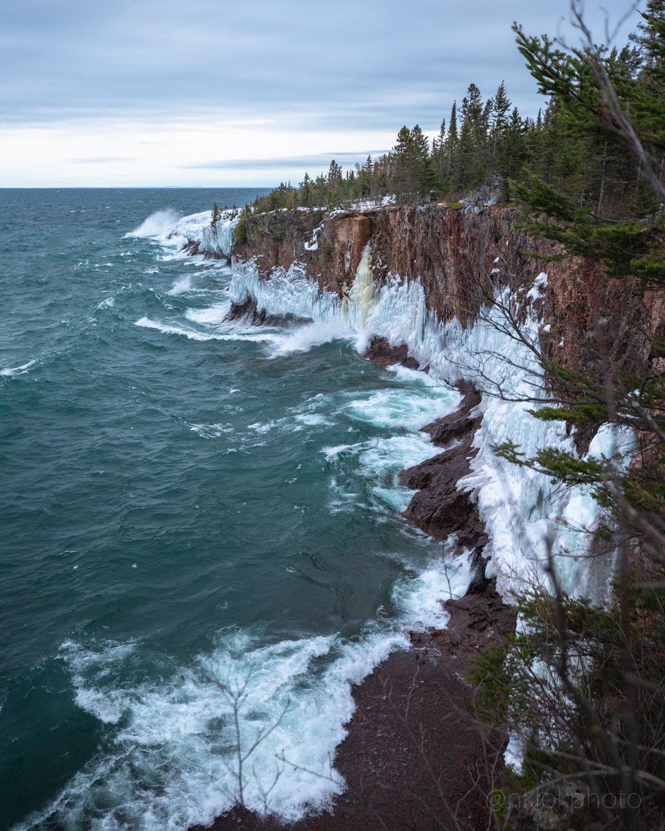 Chasing waves high atop the snowy and icy Tettegouche cliffs