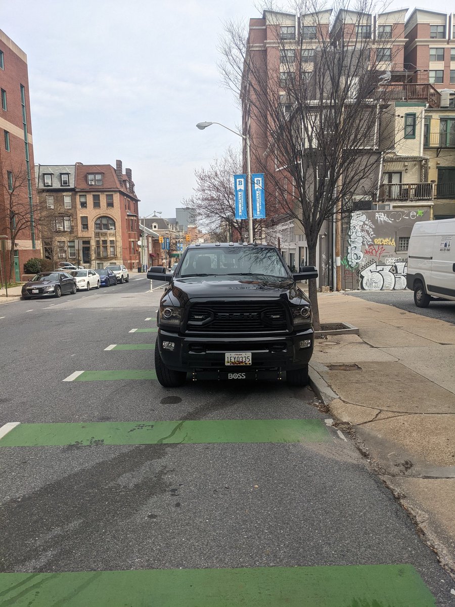 Massive truck parked in the bike lane right next to open parking spaces, nothing in the bed, gas isn't expensive enough.