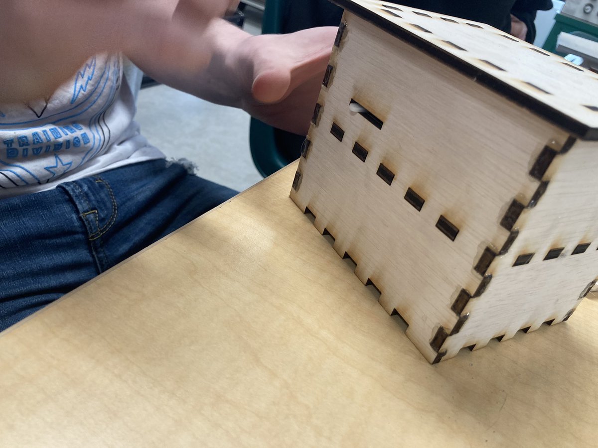 NLSD_Huck's tweet photo. Julius explaining his Knock Lock design for the #Intro2Electronics class. This is V3. He is currently making improvements for V4. This is programmed to open the lock based on number and sound of the knocks. Julius designed the box and used an @arduino . https://t.co/6W62QTaYoy