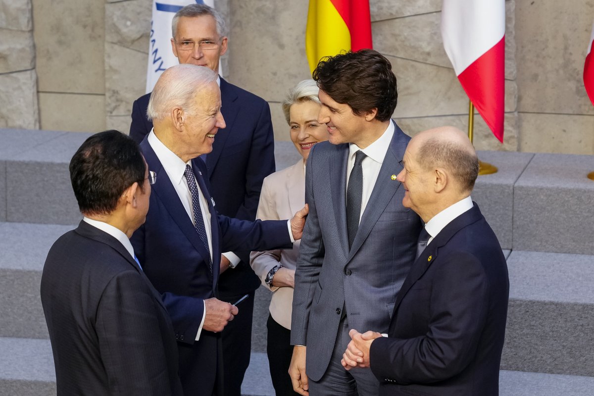 President Biden stands talking with other G7 leaders in Brussels