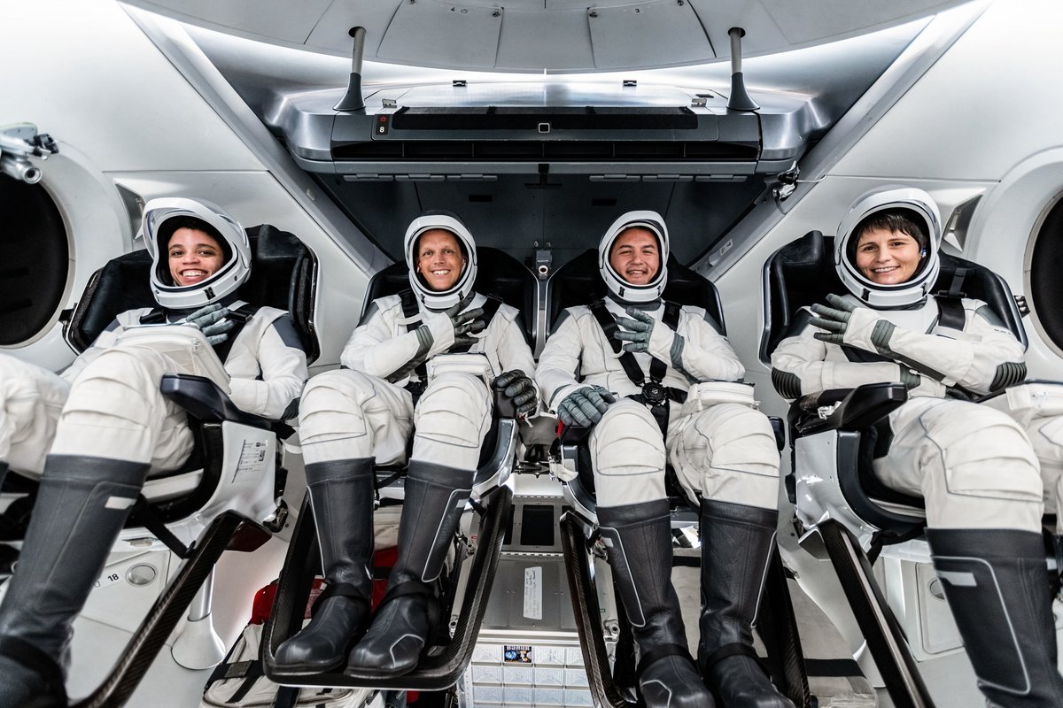 Four SpaceX Crew-4 astronauts in spacesuits seated inside Crew Dragon spacecraft