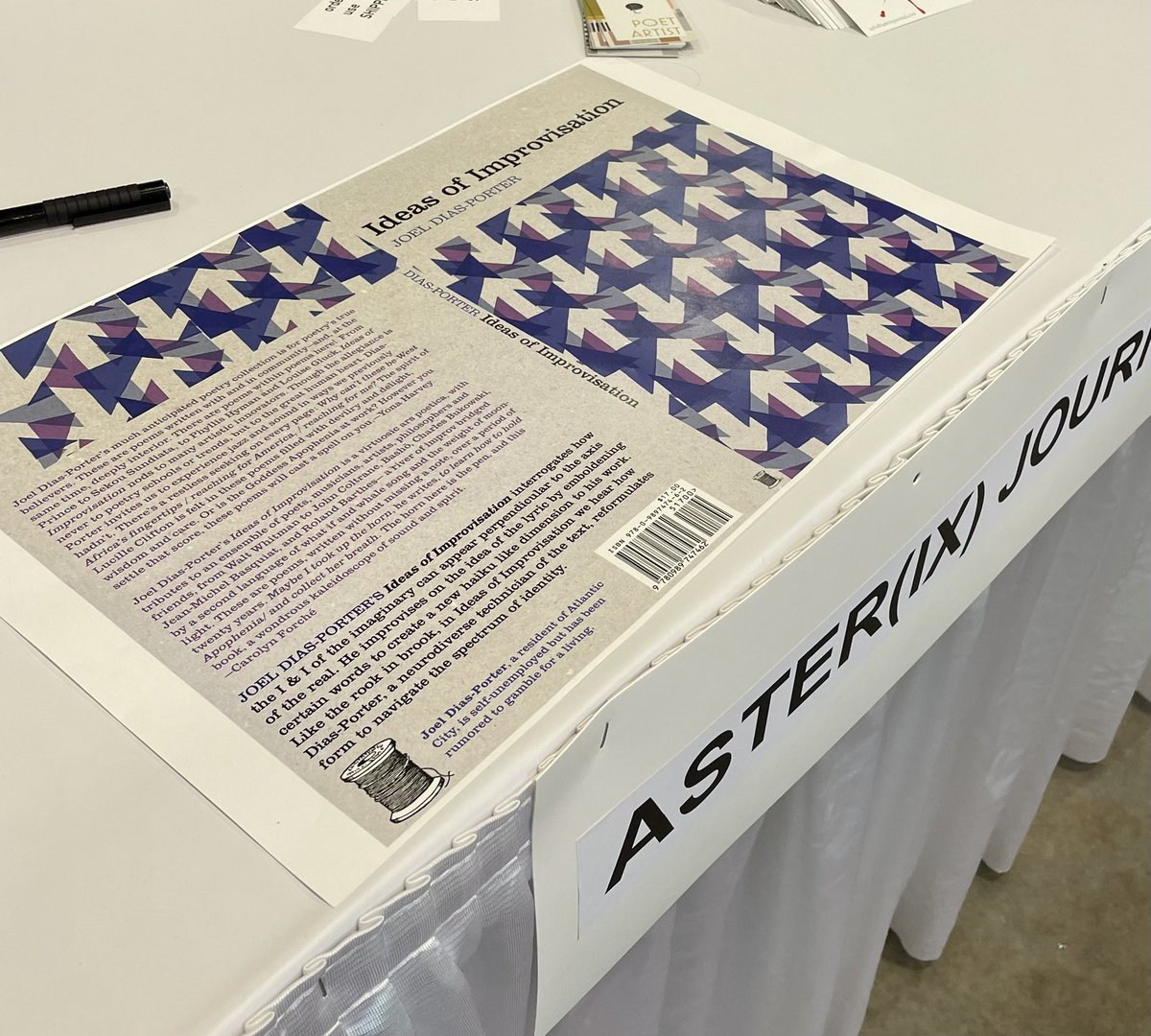 We *do not* have an AWP table, but we put the cover proof of <a href="/diasporter/">Fatha Heinz Ward 🇨🇻🇺🇸</a> ‘s forthcoming collection at the table   
@CAAPoetics is sharing w/ <a href="/asterixjournal/">Aster(ix) Journal</a> <a href="/CharlaCultural/">Charla Cultural</a> and <a href="/cityofasylum/">City of Asylum</a> 

The table is located under the big 💯 sign. Joel is a recent CAAPP writer-in-residence!