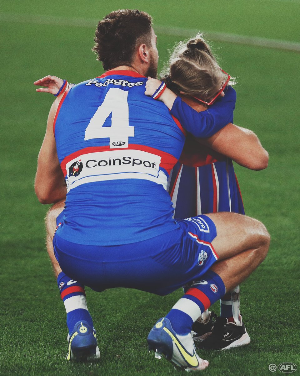 MichaelCWillson's tweet photo. Perspective ❤️🤍💙 Bulldogs mascot Lily-Fay Wilson hugs Marcus Bontempelli after running through the banner last night. Lily-Fay survived open heart surgery when she 5 weeks old and lives with Cerebral palsy but nothing was going to stop her getting through the Bulldogs banner https://t.co/kqhKVQ9yOh