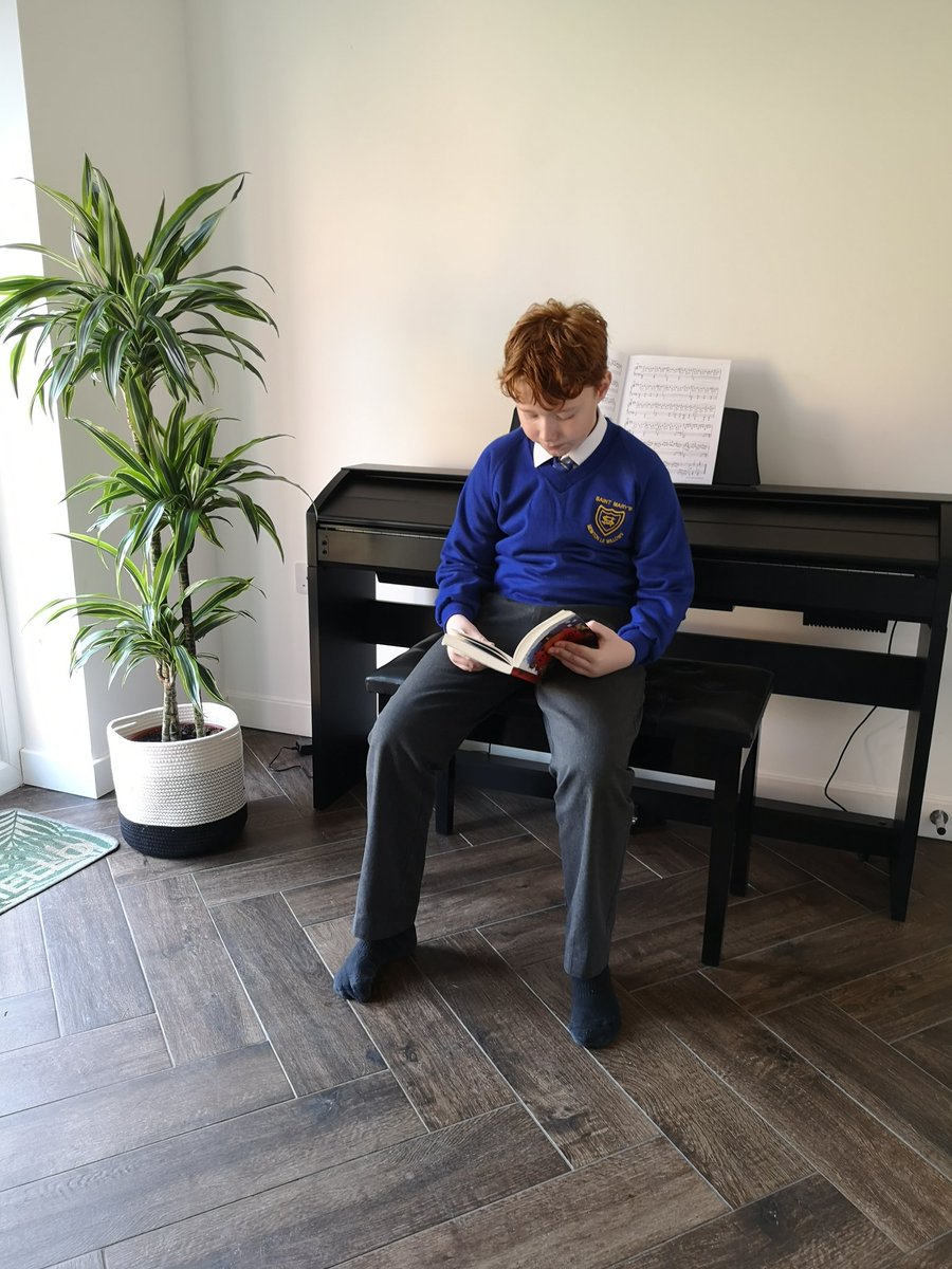 MrsNLaughton's tweet photo. #BookBingo this week, 'read somewhere strange'... So Ollie's been reading at a piano trying to ignore his loud younger brother 😂🙈 @MissMcReStMarys @MissHodkinsonSM https://t.co/9cBBBtIyj2