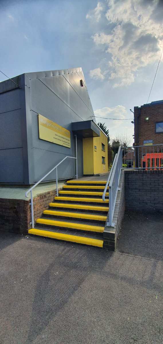 To bright fresh yellow safety steps. Ties in with the building too. Lovely