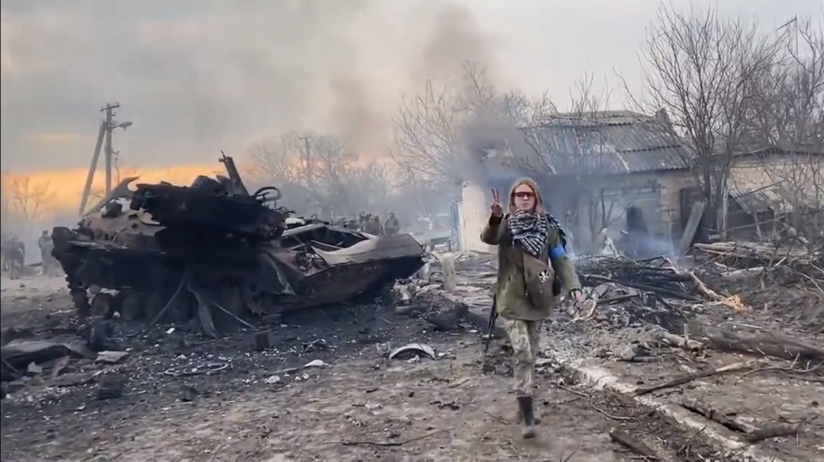 Today this young Ukrainian girl greets a soldier with a Kalashnikov strapped to her back and a peace sign in the air. I pray I never forget what true strength looks like in the face of unspeakable evil. #GloryToUkraine
