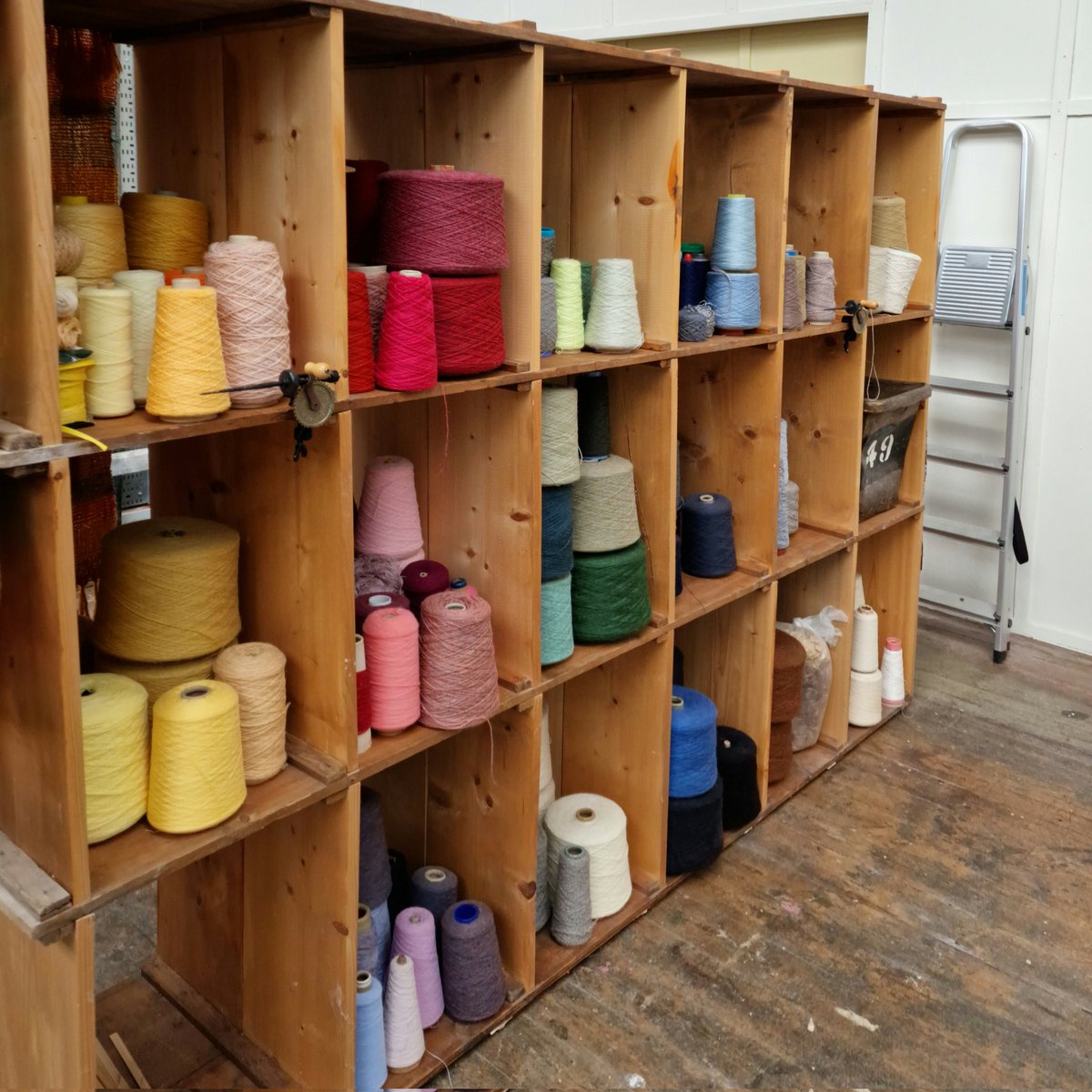 WovenByHand's tweet photo. The Wall of Yarn is Back!
All the cones of yarn came off the shelves, were moved and now all the cones are back on the shelves! Now in a wonderful light spot in the new purpose made workshop space @sunnybankmills
#weaving #workshop #tasterworkshop #weavingworkshop #craft #weave https://t.co/HU7gLNqLQy