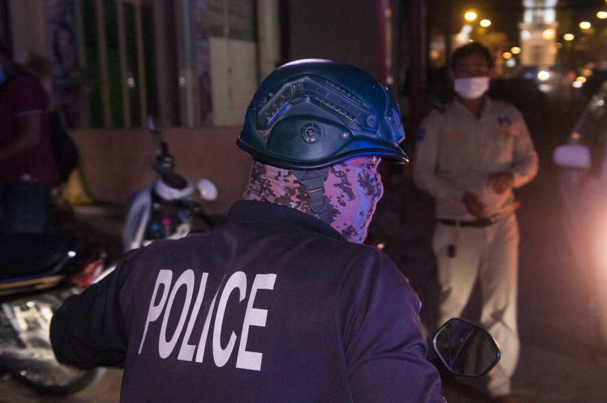 KraigLiebPhoto's tweet image. The dark days of the virus. during an outbreak of COVID-19, a Cambodian policeman in a camouflage protective face mask gets ready to leave the scene of an ambulance picking up a woman w/ coronavirus. March 14th, 2021. Phnom Penh, Cambodia.