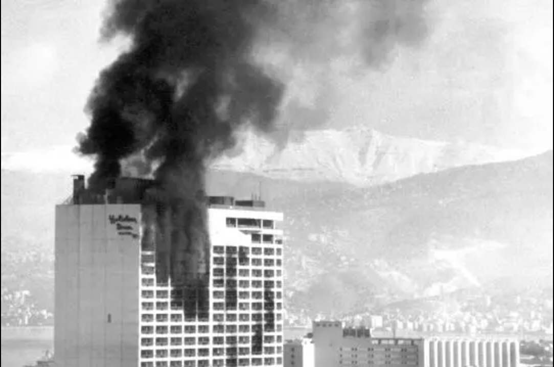 adam_tooze's tweet photo. Artillery, bombs &amp; rockets impacting high-rise buildings are today a staple of war’s visual repertoire. 
But when was the first high-rise war? Chartbook #104 on urbicide and urban war proposes Beirut 1982. Or should it have been the 1970s?
https://t.co/kNWEhVdWH1 https://t.co/AJb3sWRj0u