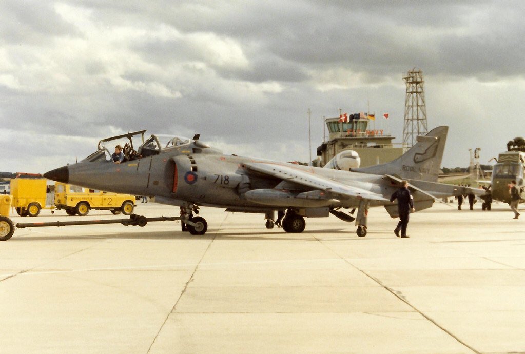 HarrierPres's tweet photo. Here’s Harrier T.4N ZB605 being towed out, note the open nose and rear gear bays, and the “Jungly” in the background. Sometime in the mid1980s.  Photographer, Kerry Taylor #899NAS #Harrierpres #HarrierTbird #HarrierT4N https://t.co/Yw01Iy0z6Y