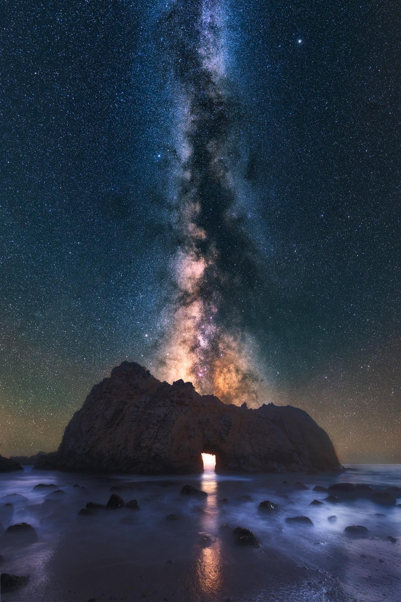 Milky Way shining through an arch on the California Coast